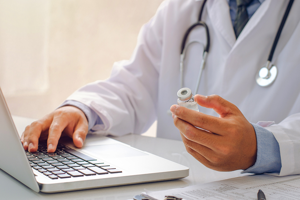 Doctor doing research on laptop